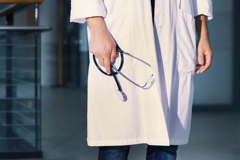 A doctor in a white coat.