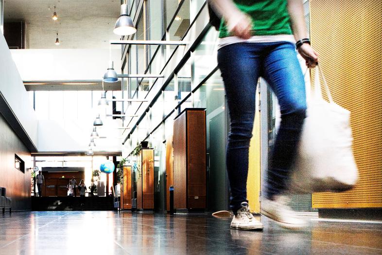 A student walking down the hallway in Physicum.