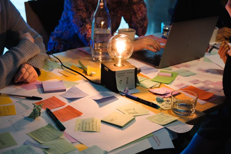 Stickers on the table, light bulb in the middle.