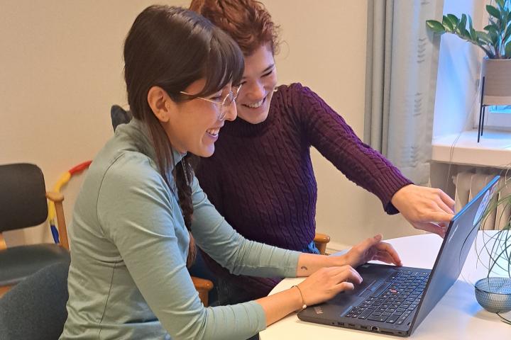 Two students working on a laptop.