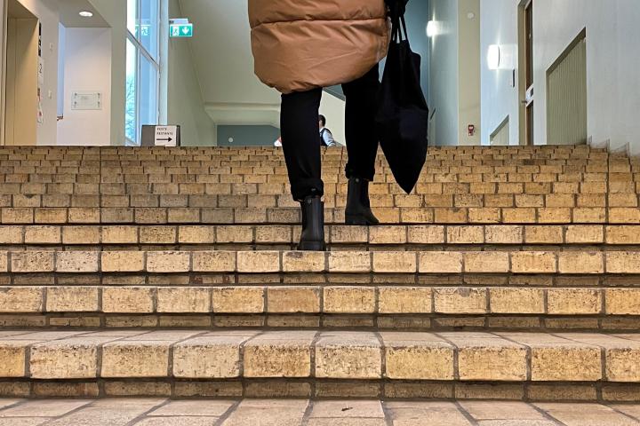 A student walking up the Forest House stairs.